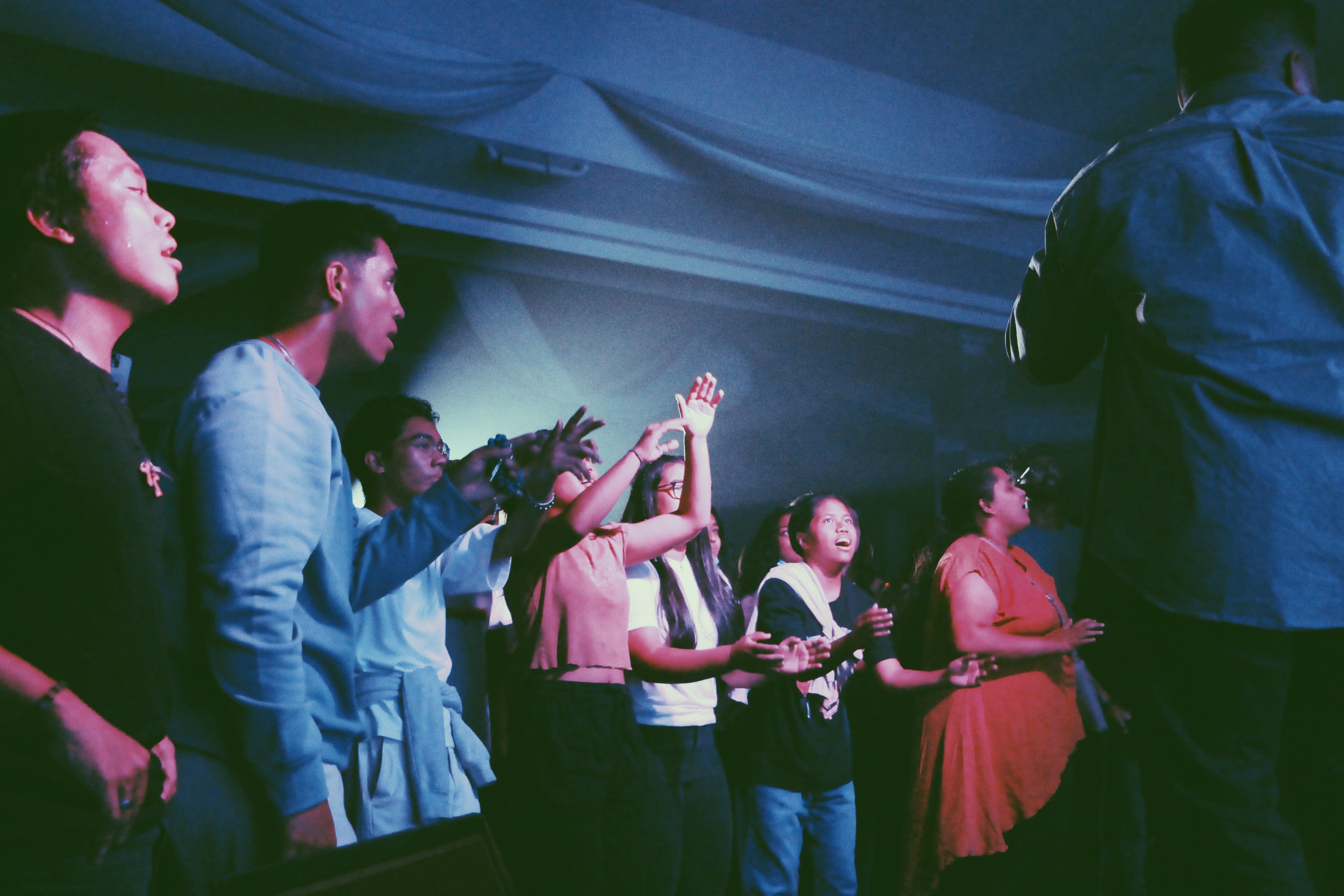 Congregation in worship, blue light